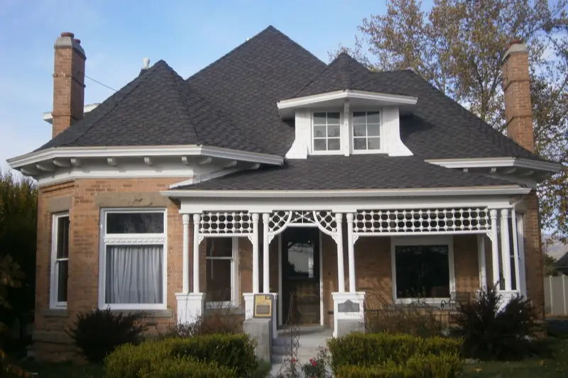 A brick bungalow with a hip roof in Holladay, Utah