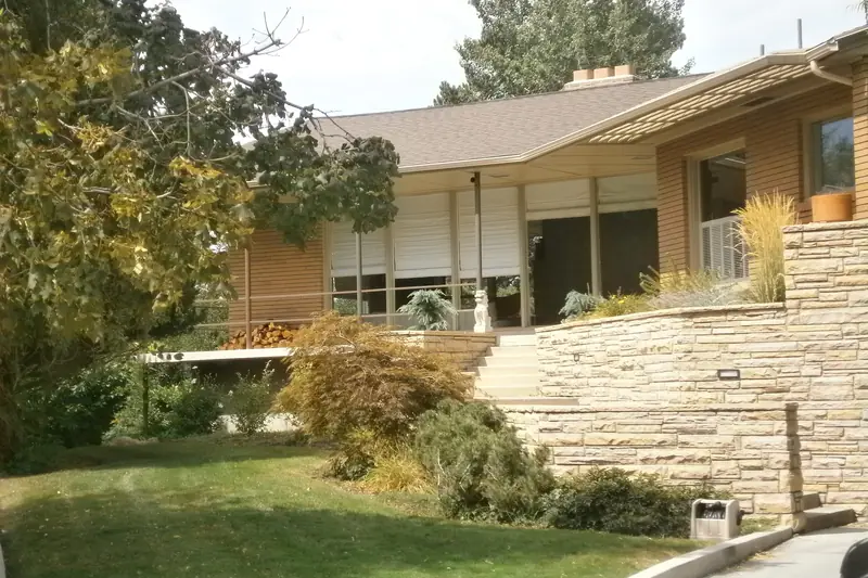 A mid-century home with a stone retaining wall in Salt Lake City